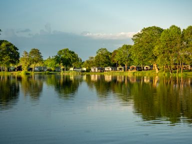 A view of cabins near a lake at Dove in Shobdon
