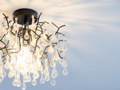 A ceiling light fixture with hanging glass teardrop decorations at School Lodge in Llandeilo