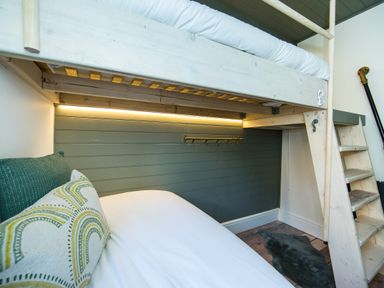 A bunk bed with a ladder and pillows in a bedroom at Casa Formentera in Scarborough