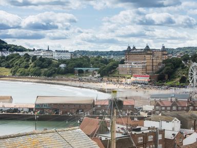 A coastal town with a beach a large building a ferris wheel and residential buildings at Casa Formentera in Scarborough
