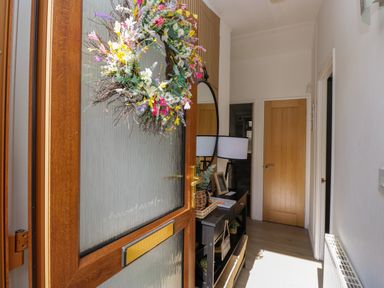 A hallway with a console table and lamp at Ruskin Lodge, Langdale 16, White Cross Bay near Windermere