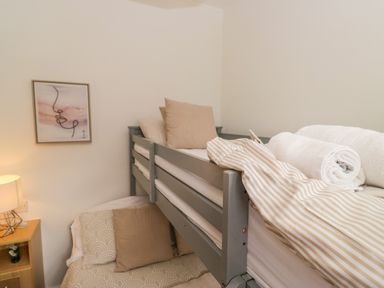 A bunk bed with blankets and pillows at Ruskin Lodge, Langdale 16, White Cross Bay near Windermere