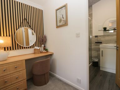 An office space with a desk and a mirror at Ruskin Lodge, Langdale 16, White Cross Bay near Windermere
