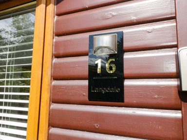 A door with house number 16 and light fixture at Ruskin Lodge, Langdale 16, White Cross Bay near Windermere
