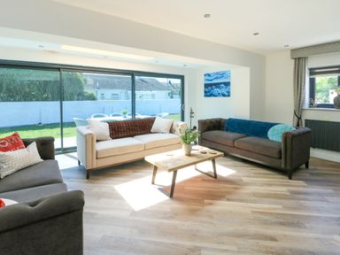 A living room with sofas and a coffee table at Iscoed in Rhosneigr