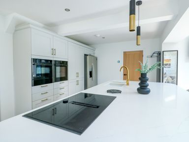 A kitchen with cabinets and appliances at Iscoed Rhosneigr