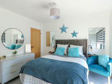 A bedroom with a bed and nightstand at Iscoed Rhosneigr
