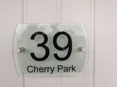 A house number sign showing 39 Cherry Park on a white door at 39 Cherry Park in Chapel St Leonards