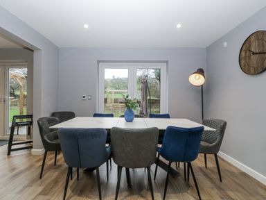 A dining room with a table and chairs at Ranbir House in Longhope