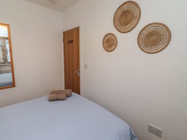 A bedroom with a bed and decorative wall items at Brucap Cottage Beadnell