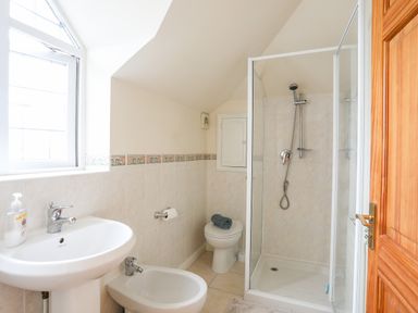 A bathroom with a sink bidet toilet and shower at Bwthyn in Borth-y-Gest near Porthmadog