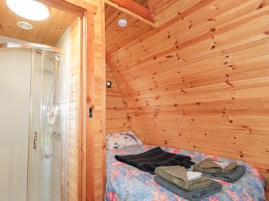 A bedroom with a bed and shower at Pod 1