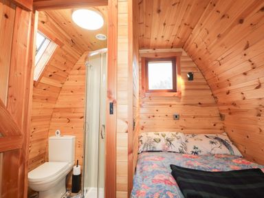 A bedroom with a bed and an attached bathroom at Pod 1