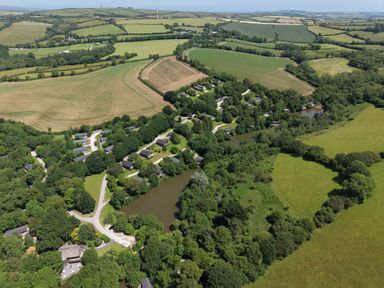 An aerial view of fields and houses at 4 Valley View in Lanreath