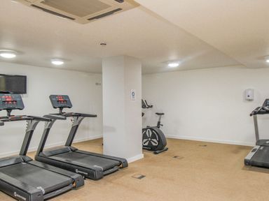 A gym room with treadmills and a stationary bike at Sunset View in Castletown Portland