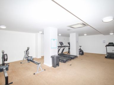 A fitness room with exercise bikes and treadmills at Sunset View in Castletown Portland