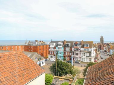 View of rooftops trees buildings and the sea in the background at Flat 3 in Cromer