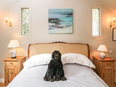 A bedroom with a bed and stuffed gorilla toy on it at The Barn at Westhall Cottage Fulbrook near Burford