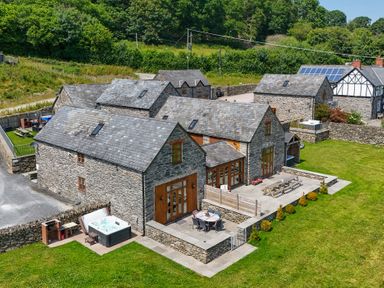 An outdoor area with buildings and a jacuzzi at Hay Store in Corwen