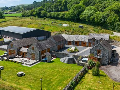 An outdoor view of multiple buildings and grounds at Hay Store in Corwen