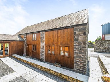 A building with wooden and stone walls at Hay Store in Corwen
