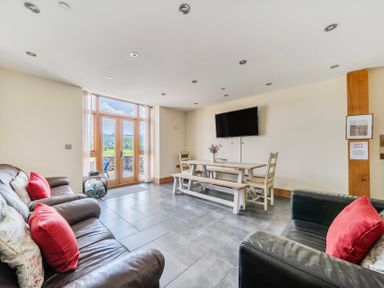 A living room with seating and dining table at Hay Store in Corwen