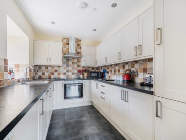 A kitchen with cabinets and appliances at Hay Store in Corwen