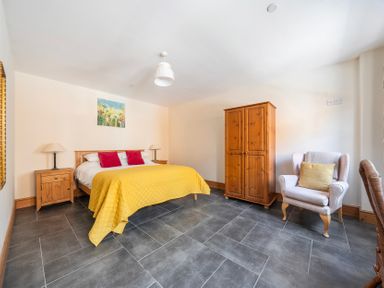 A bedroom with a bed and wardrobe at Hay Store in Corwen