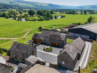 An aerial view of buildings and landscape at The Barn in Corwen