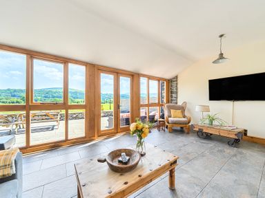 A living room with a view and a coffee table at The Barn in Corwen