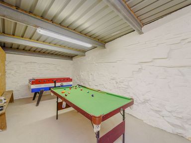 A game room with a pool table and foosball table at The Druids in Druid near Corwen