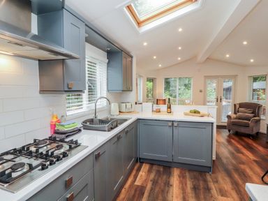A kitchen with a gas stove and sink at Willows Lodge near Windermere