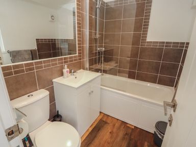 A bathroom with a sink, bath tub and shower at Willows Lodge White Cross Bay near Windermere