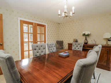 A dining room with a table and chairs at The Old Hall in Tetbury