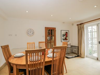 A dining room with a table and chairs at The Old Hall in Tetbury