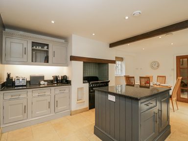 A kitchen with cabinets and appliances at The Old Hall in Tetbury