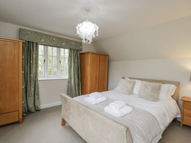 A bedroom with a bed and wardrobes at The Old Hall in Tetbury