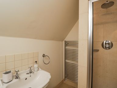 A bathroom with a tub and shower at The Old Hall in Tetbury