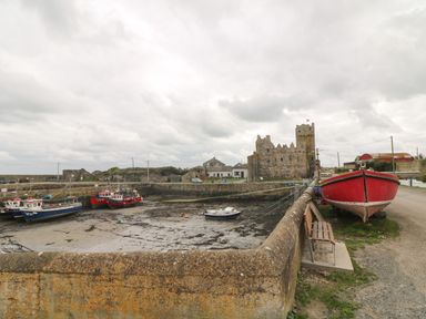 A small harbor with boats and an old stone castle at Old Field Hideaway Slade near Fethard-On-Sea County Wexford