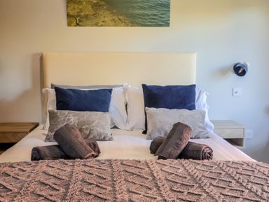 A bedroom with a bed and pillows at Sir George Baker Cabin in Uplyme
