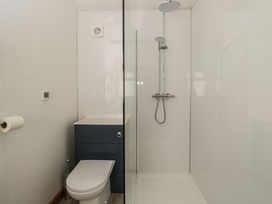 A bathroom with a toilet and a walk in shower at Keepers Barn in Bromyard