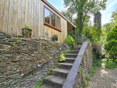 A wooden structure with steps and plants at Ty Barddu in Cwmorgan near Newcastle Emlyn