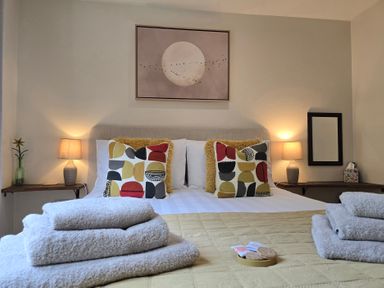 A bedroom with a bed and decorative pillows at Ty Barddu in Cwmorgan near Newcastle Emlyn