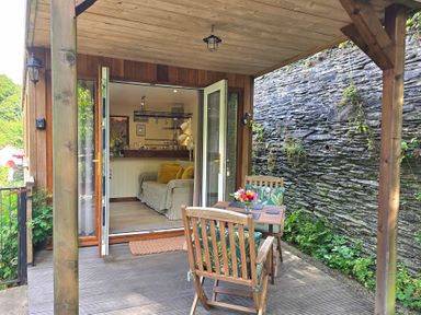 An outdoor patio with a table and chairs at Ty Barddu in Cwmorgan near Newcastle Emlyn