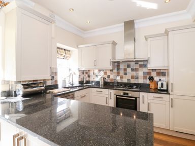 A kitchen with granite countertops stove oven kettle toaster and knife block at Silver How in Ambleside