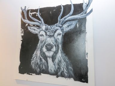 A painting of a stag with antlers on a black and white canvas