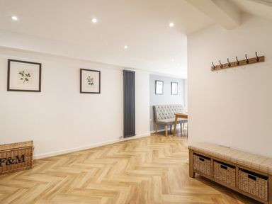 A dining room with a table and chairs at Neptune Cottage in Conwy