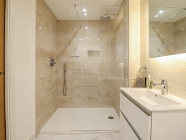 A bathroom with a shower and a sink at Neptune Cottage in Conwy