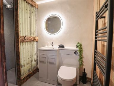 A bathroom with a sink and toilet at Godre'r Gyrn, Plas Moelfre Hall Barns, Oswestry