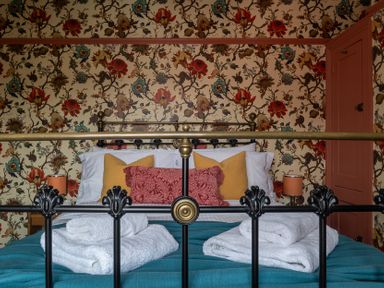 A bedroom with a bed and pillows at Astondene, East Cliff Southwold